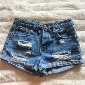 Forever 21. Distressed denim cut off shorts. Size 27.